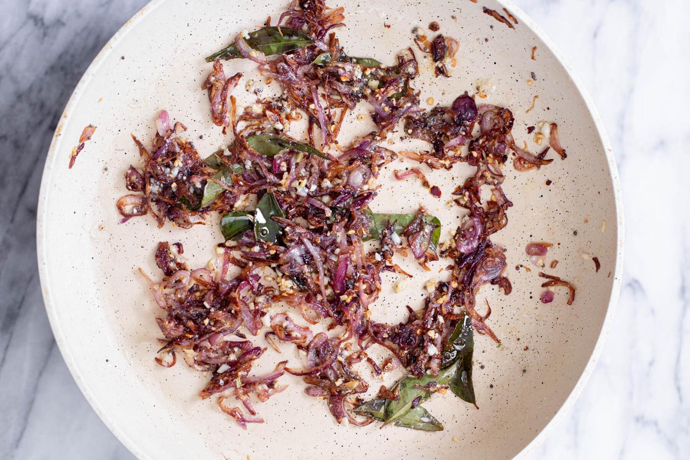 fried onion and garlic in a sauteeing pan