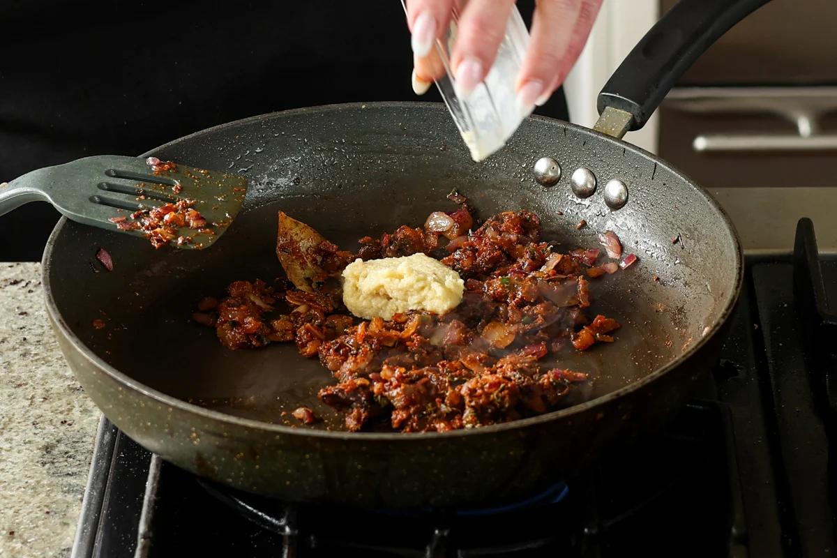 adding ginger garlic paste to the pan