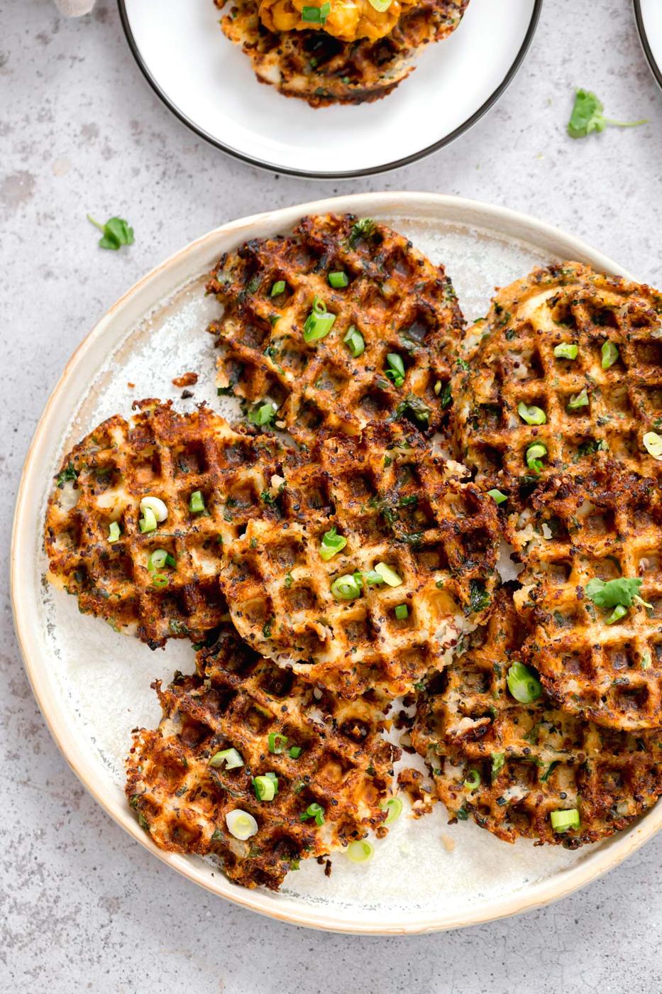 crispy vegan potato quinoa waffles topped with chopped chives