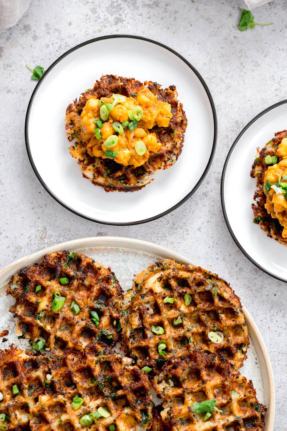 vegan quinoa potato waffles topped with chopped chives and smashed chickpeas