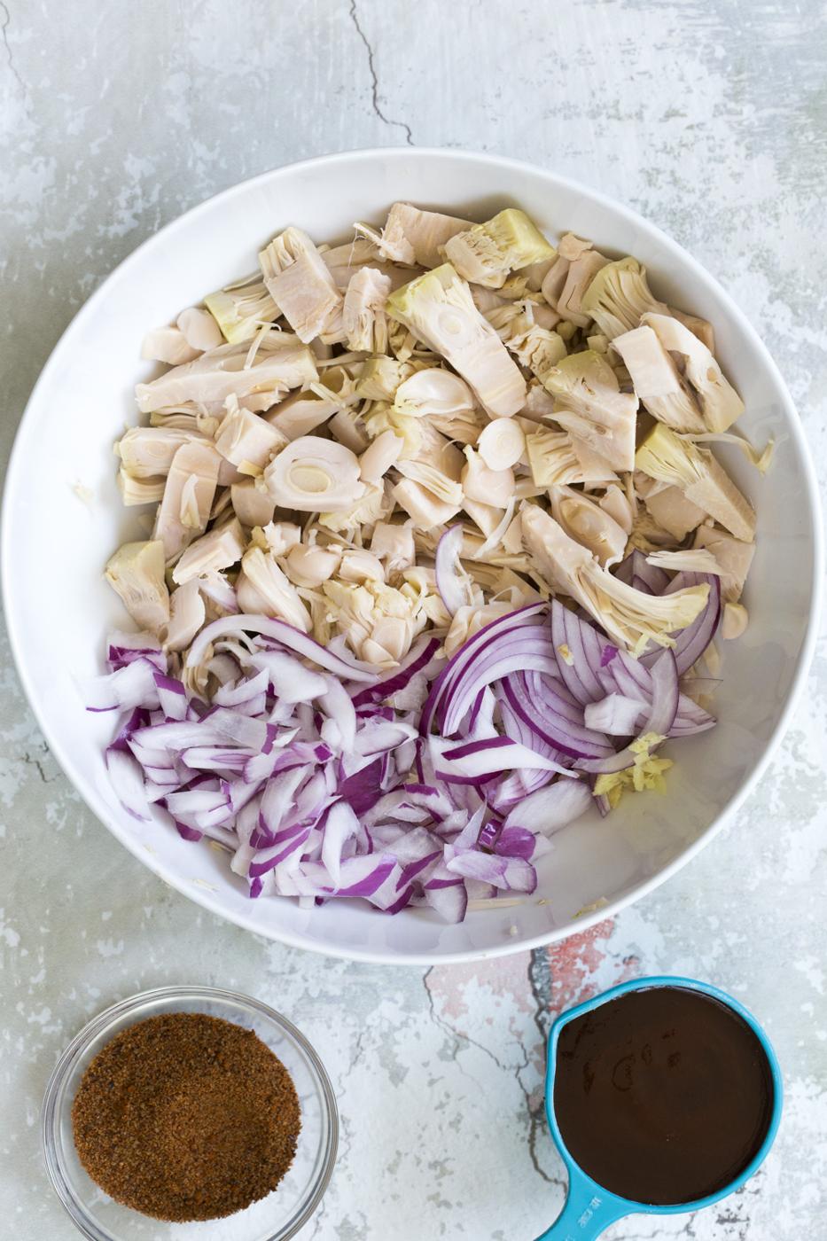 Shredded Jackfruit and onion in a white bowl for our Vegan Pulled Jackfruit Sandwiches