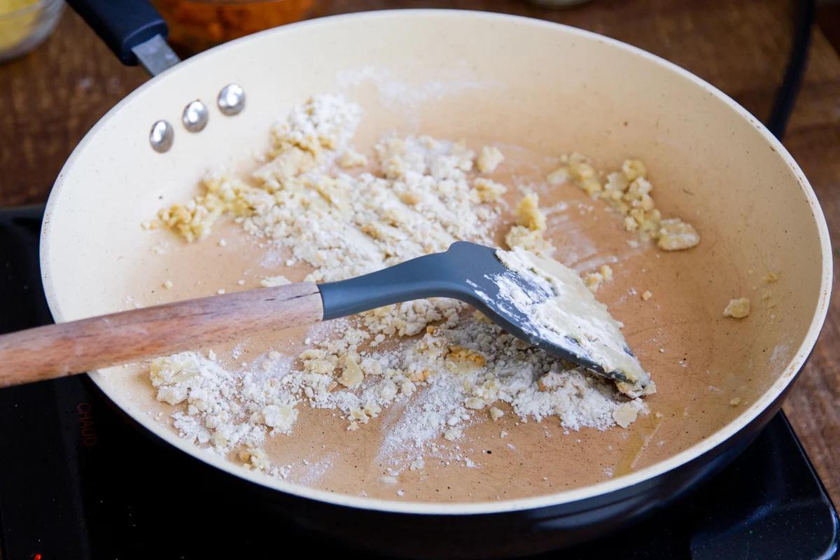 adding flour to the sautéed garlic