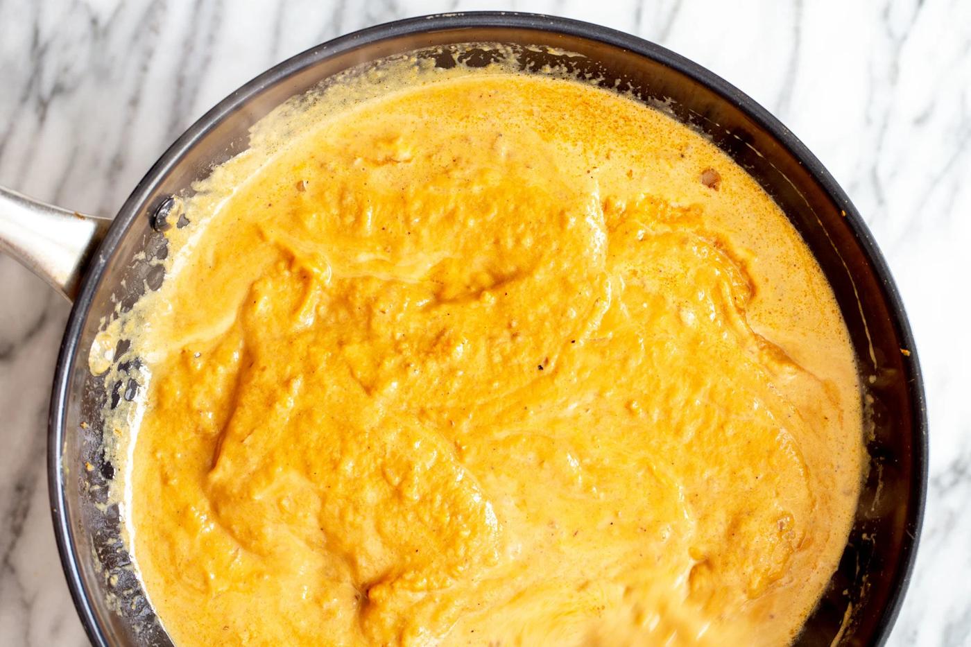 overhead shot of a skillet with simmering pumpkin curry