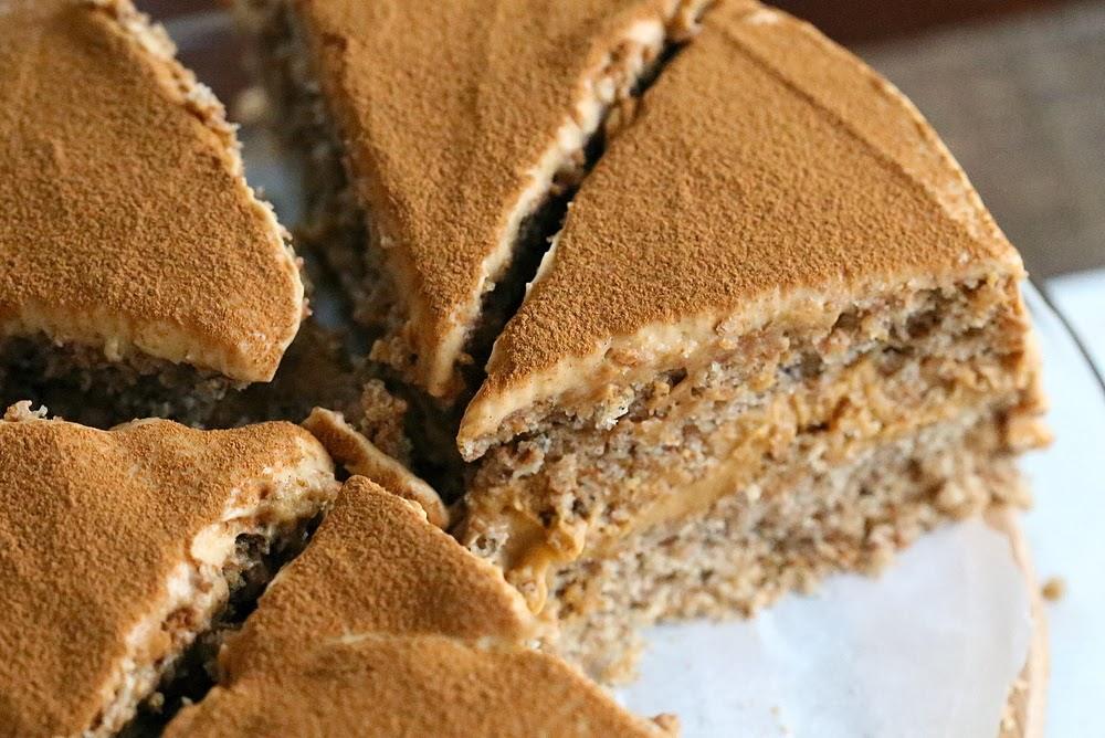 close-up overhead shot of a vegan pumpkin layer cake filled with pumpkin mousse on a cake stand