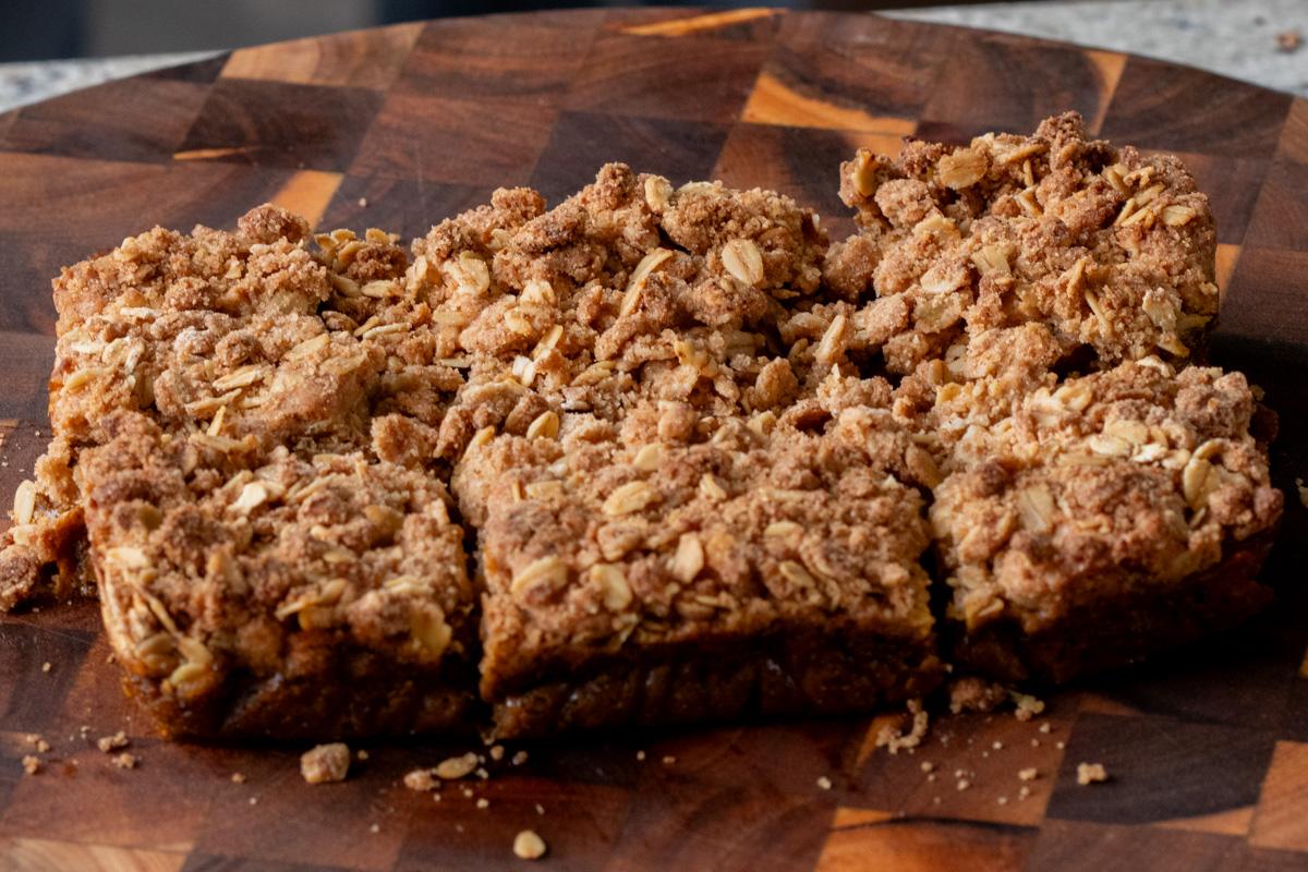 sliced pumpkin crisp on the cutting board, after removing from the baking pan