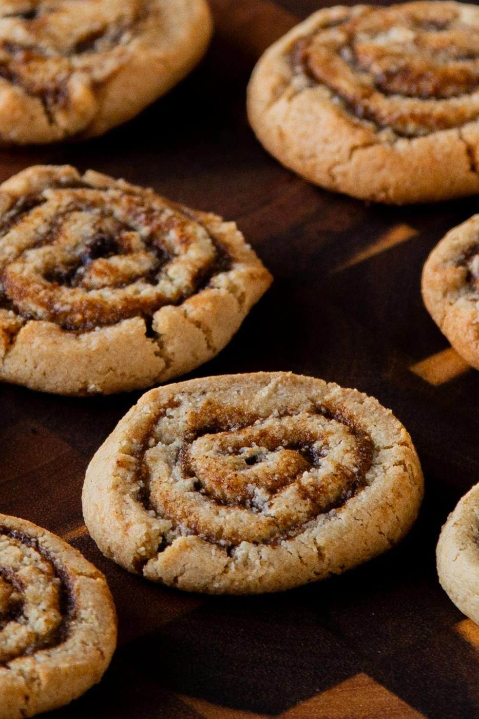 pumpkin spice roll cookies on a wooden tray