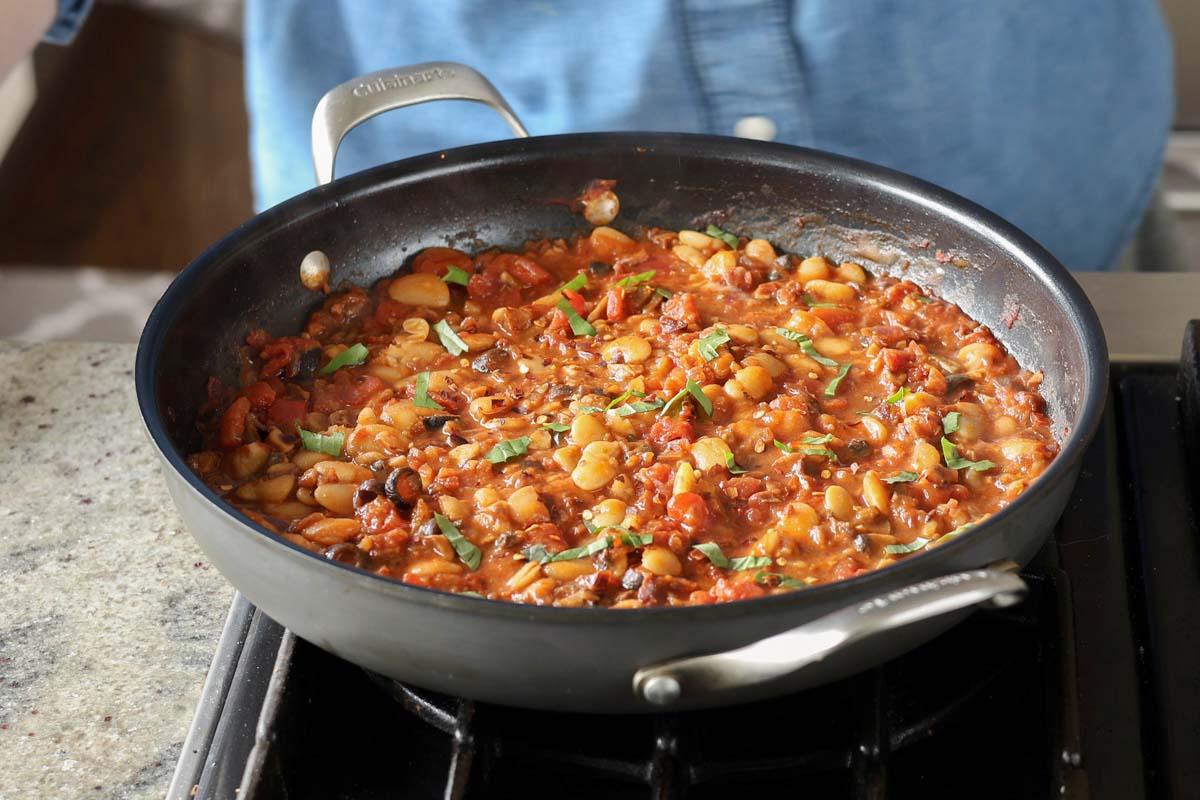 puttanesca beans in the pan after simmering