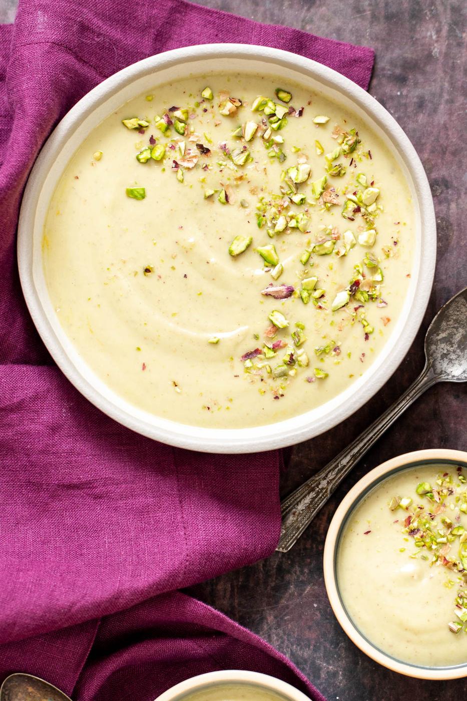 three bowls of Indian rabri pudding chopped with pistachio