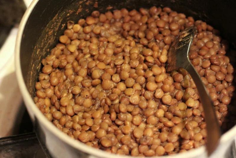 lentils cool in a stainless steel pot with spoon