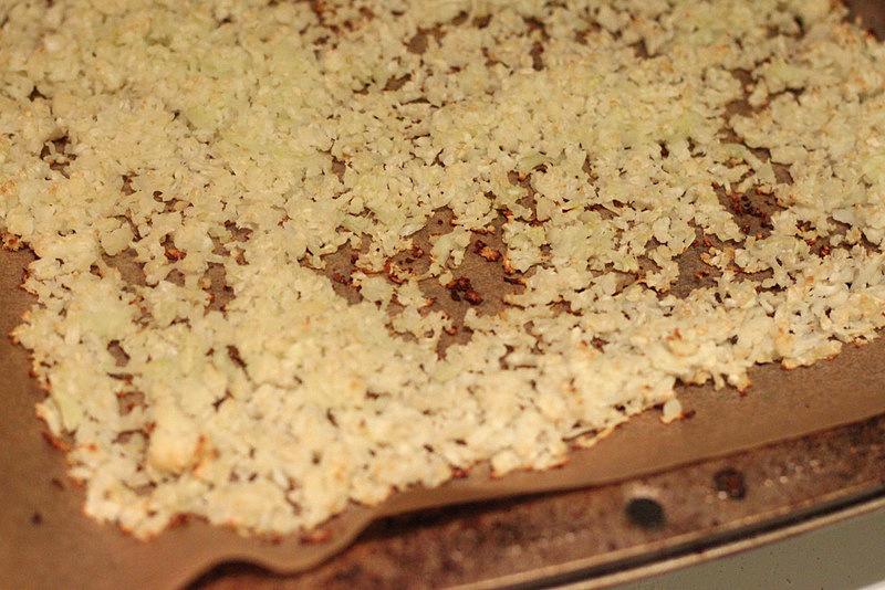 baked grated cauliflower on parchment paper