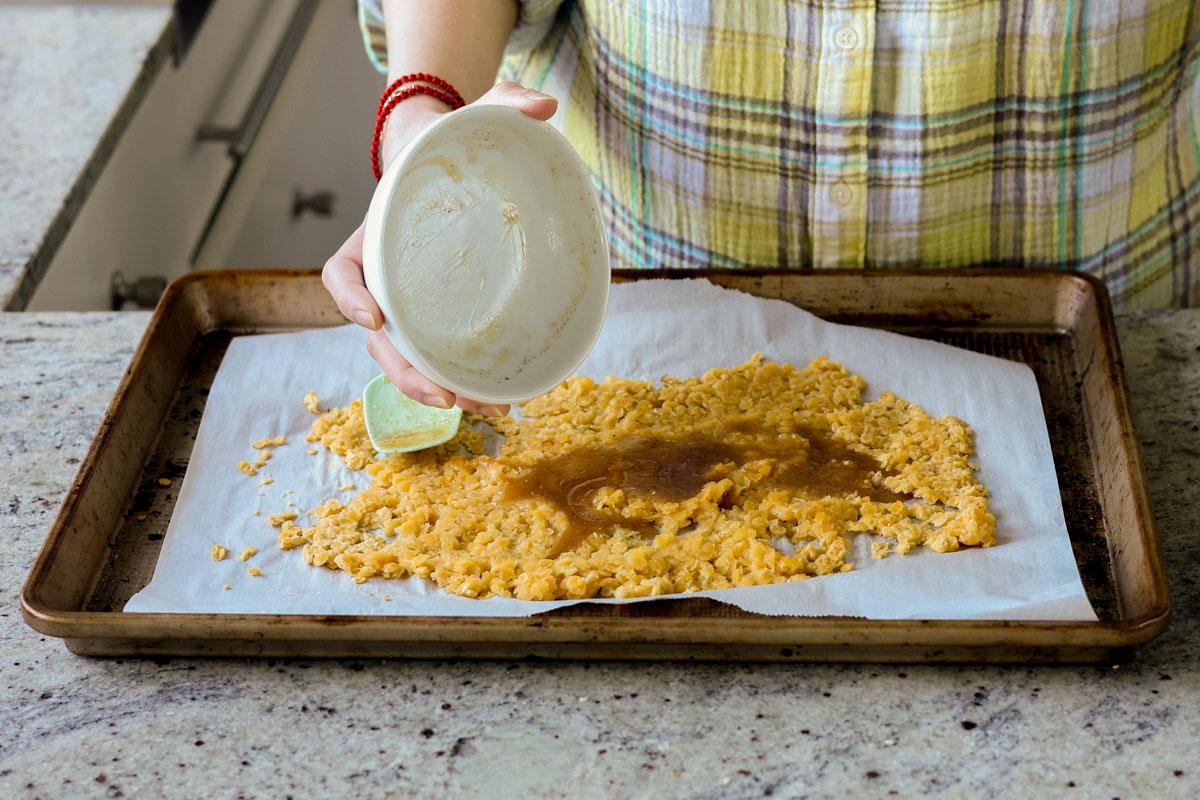 adding maple syrup mixture to the red lentils