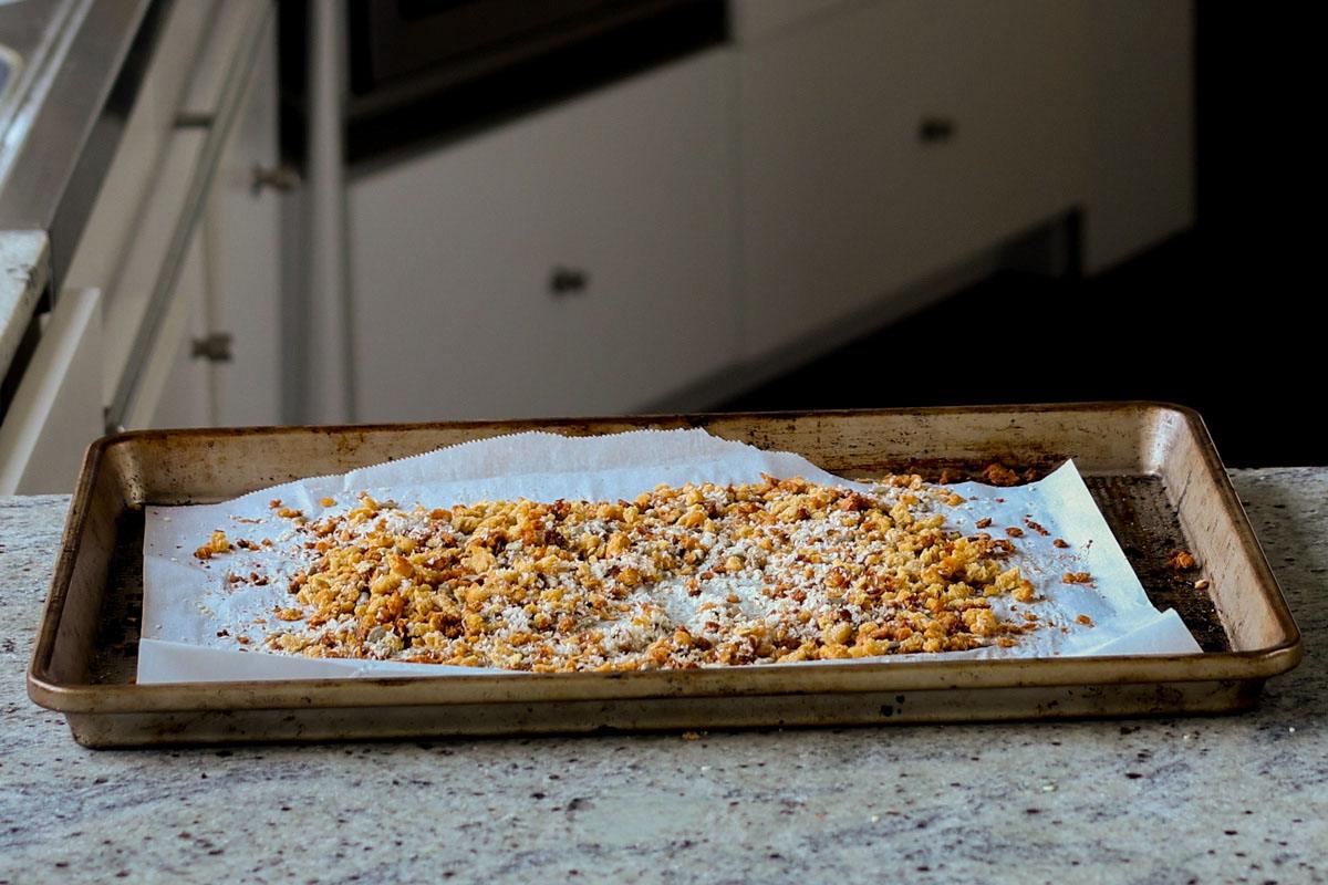 red lentil granola spread out on the baking pan, after baking