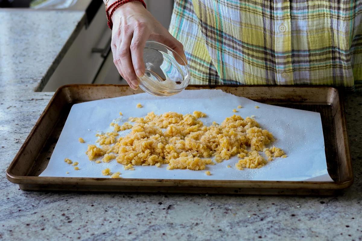 adding red lentils to the baking pan