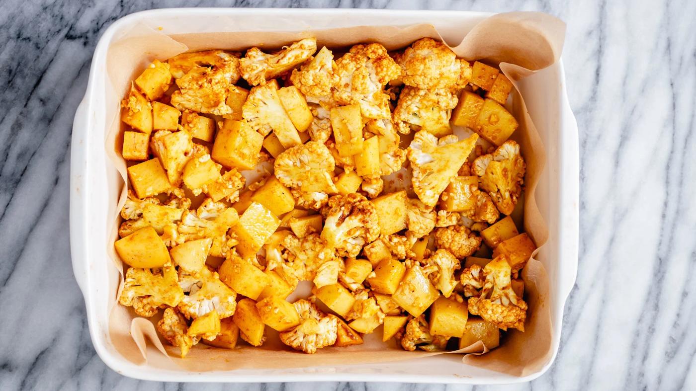 cauliflower and potato cubes in a casserole dish