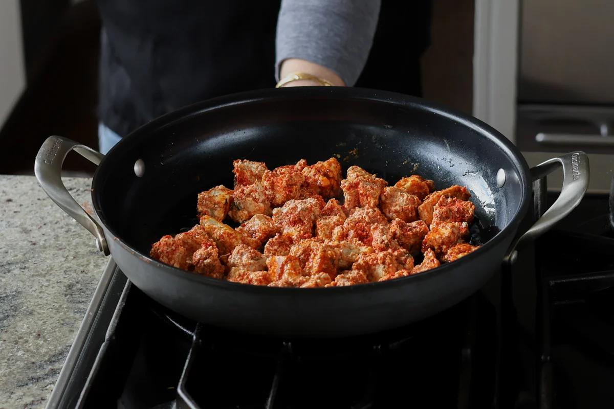 adding tofu to the pan