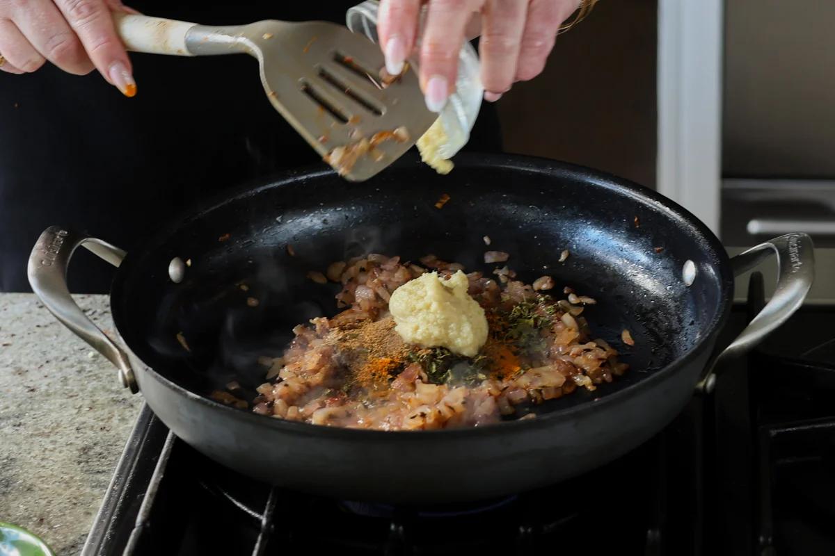 adding ginger garlic paste to the pan