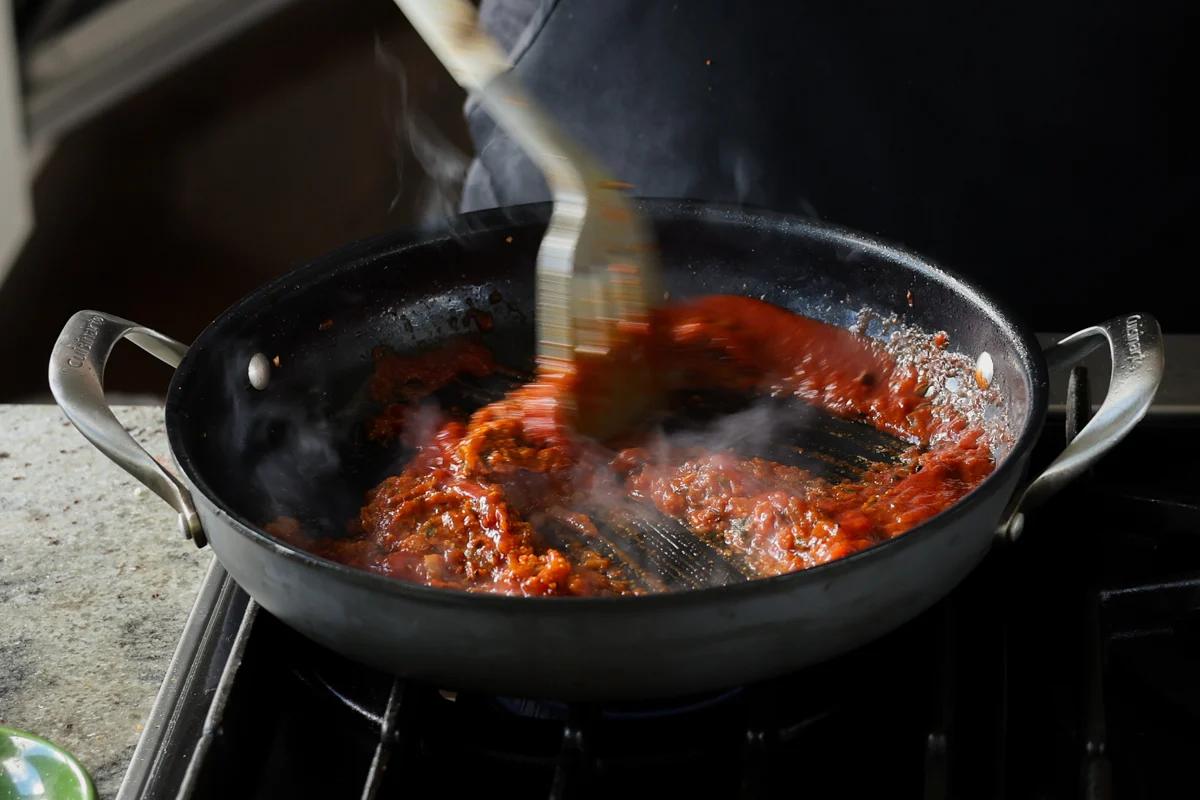 mixing in the tomato puree