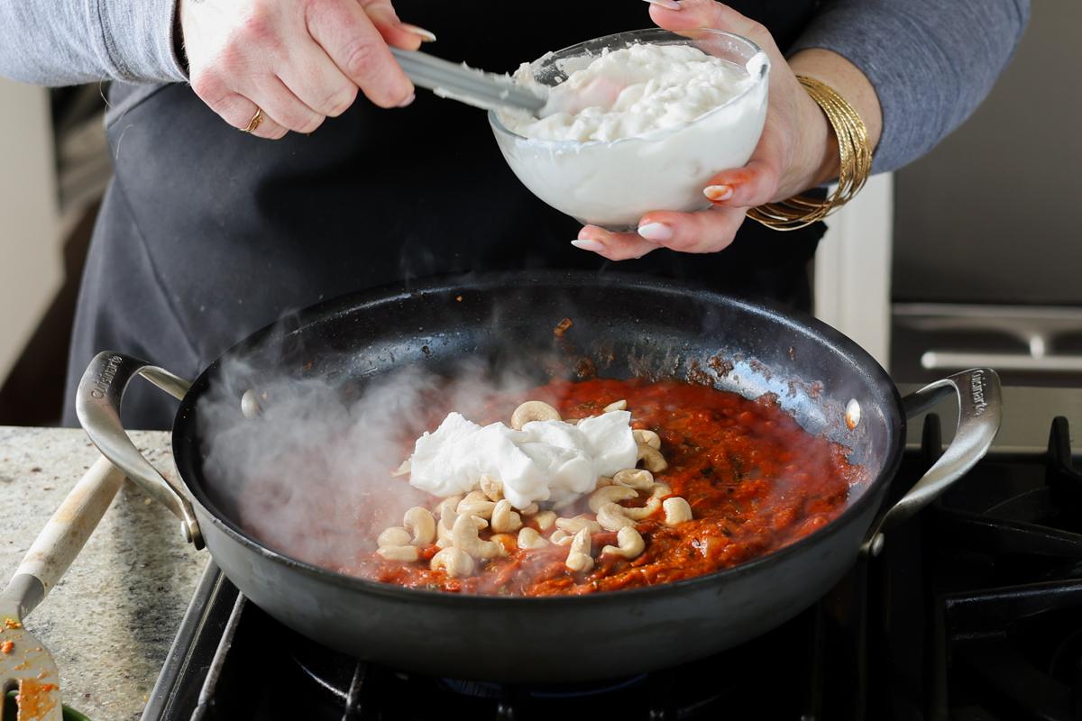adding coconut cream to the pan