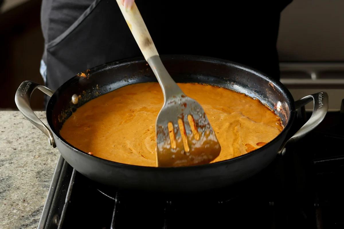 bringing the blended sauce mixture to a boil I the pan