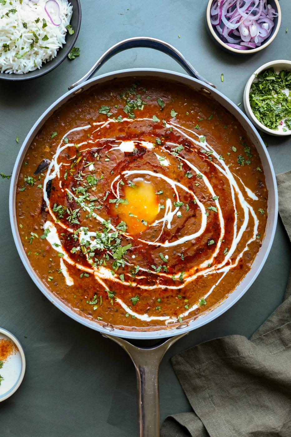 dal makhani in the pan with tadka and toppings
