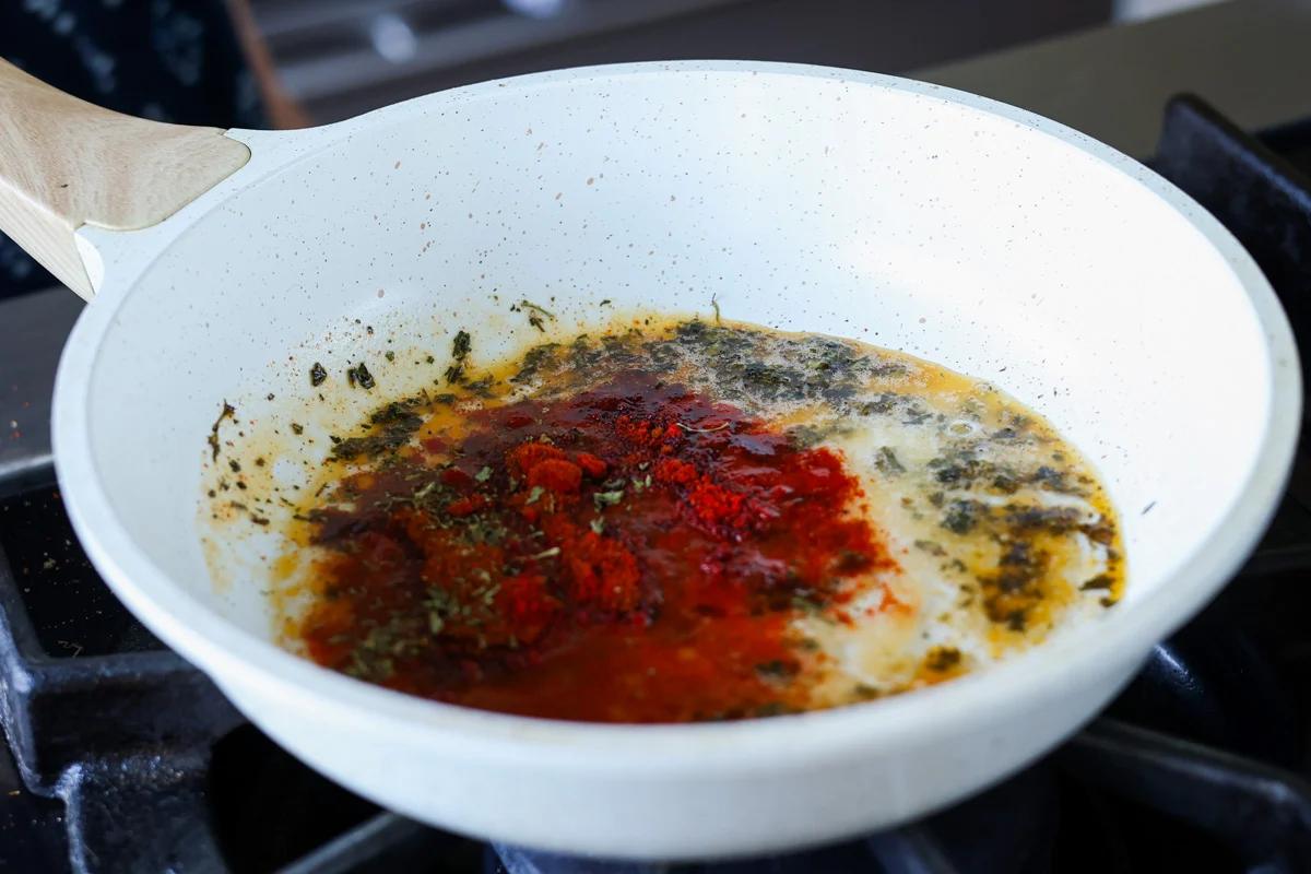 adding kashmiri chili powder to the pan