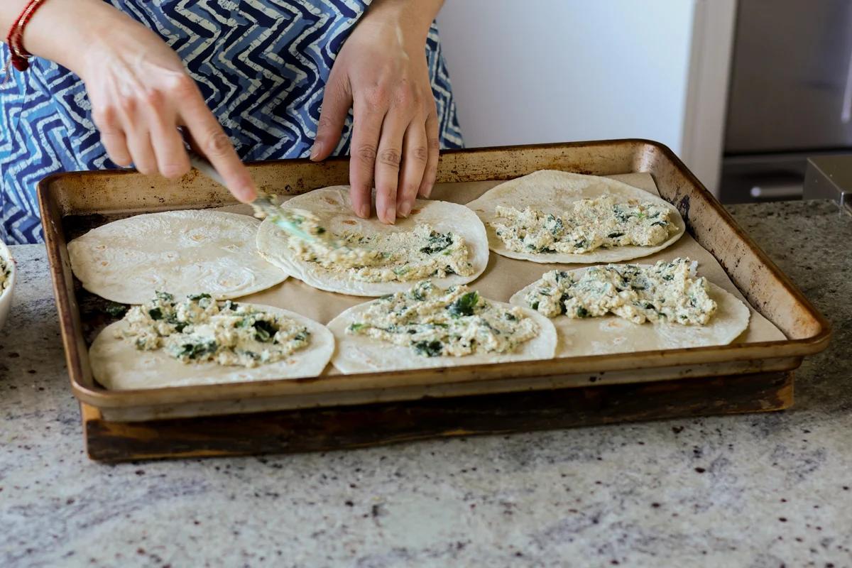 assembling the tacos on a baking pan