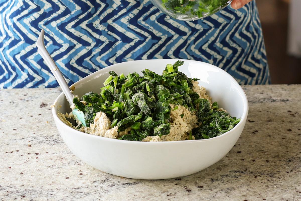 adding spinach to the tofu mixture
