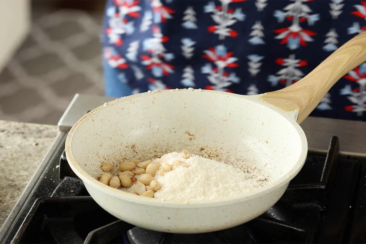 coconut and peanuts in the pan before toasting