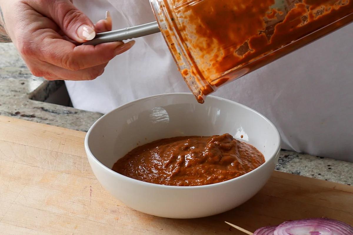 transferring sun dried tomato spread to a bowl
