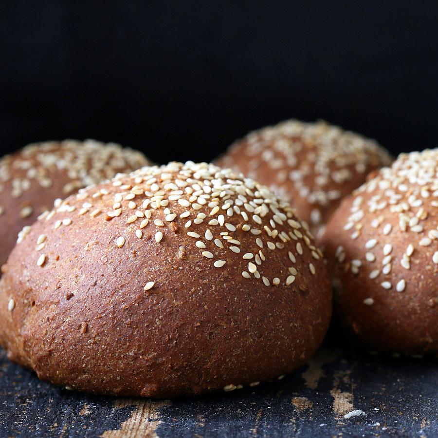 side view of vegan burger buns sprinkled with sesame seeds