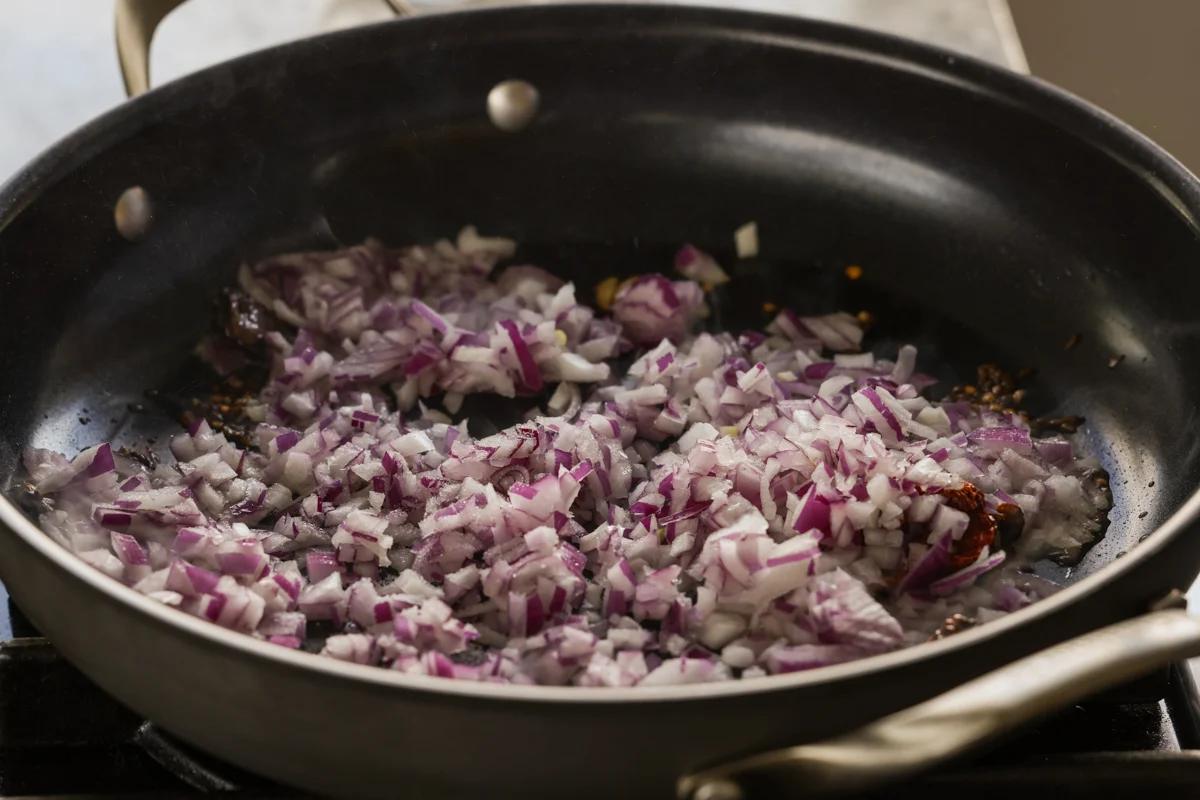 adding onions to the pan