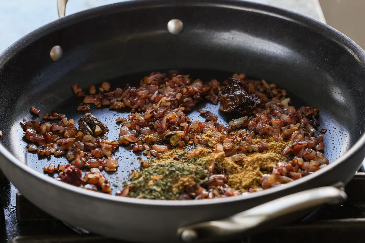 adding spices to the cooked onions