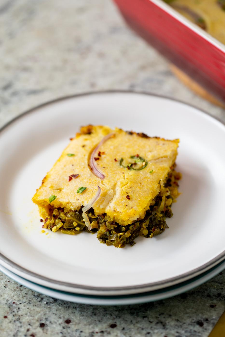 a slice of saag cornbread casserole on a white plate