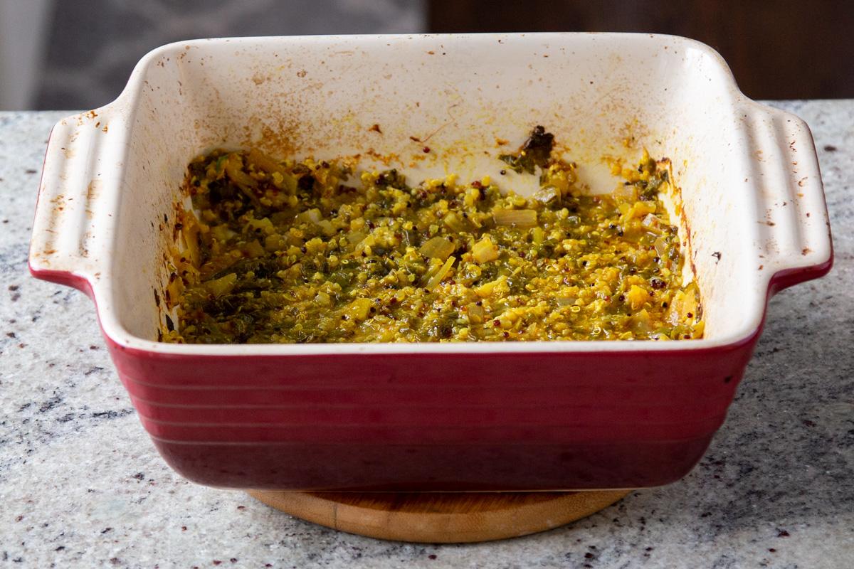 baked Indian saag stew in a red casserole dish