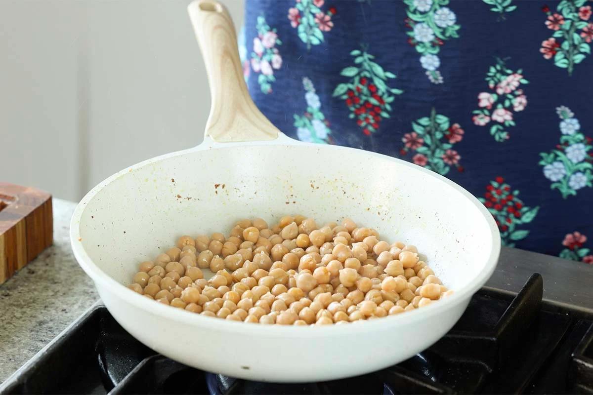 adding chickpeas to the pan