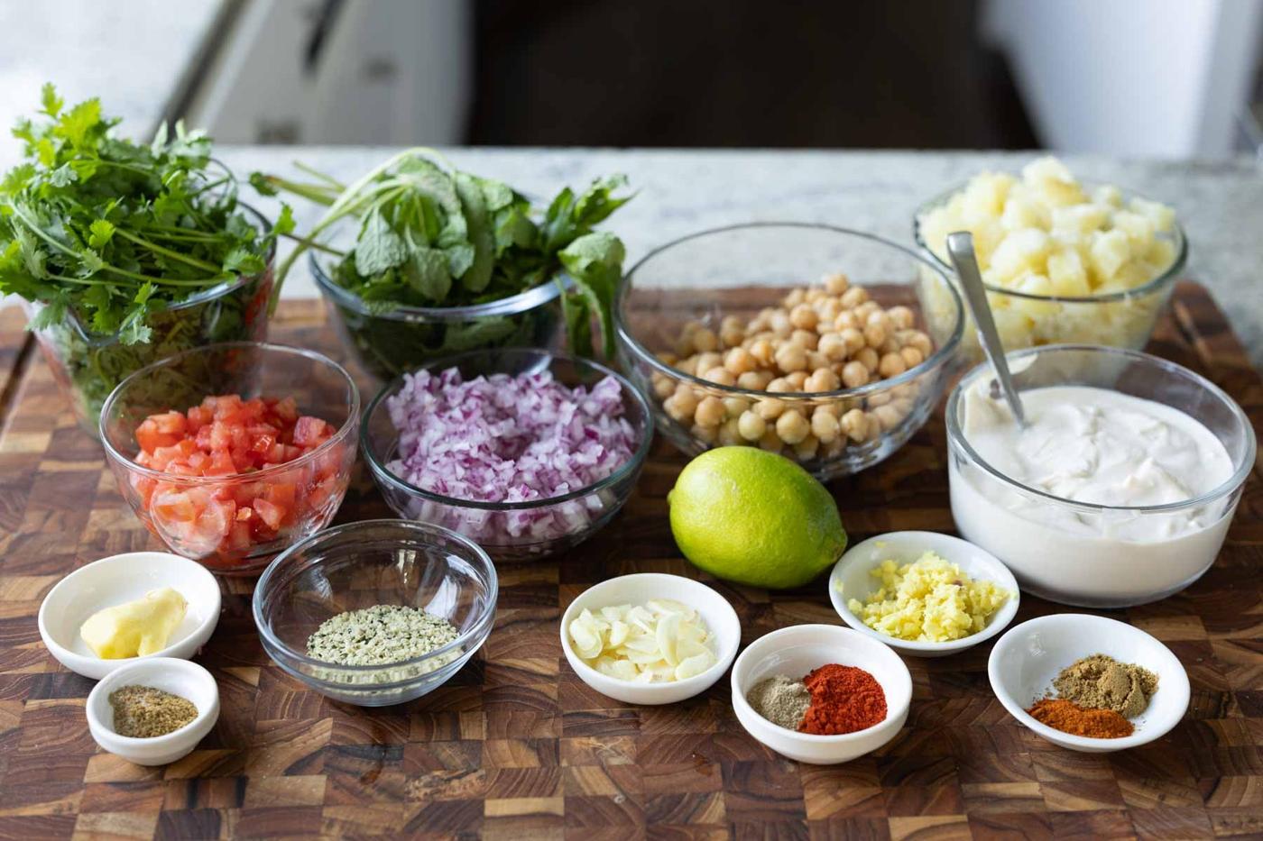 samosa chaat platter ingredients on the kitchen counter