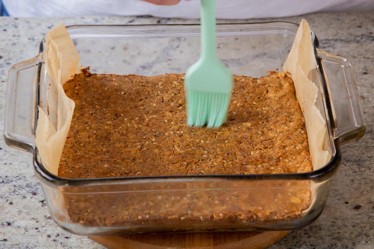 brushing oil onto baked savory granola bars