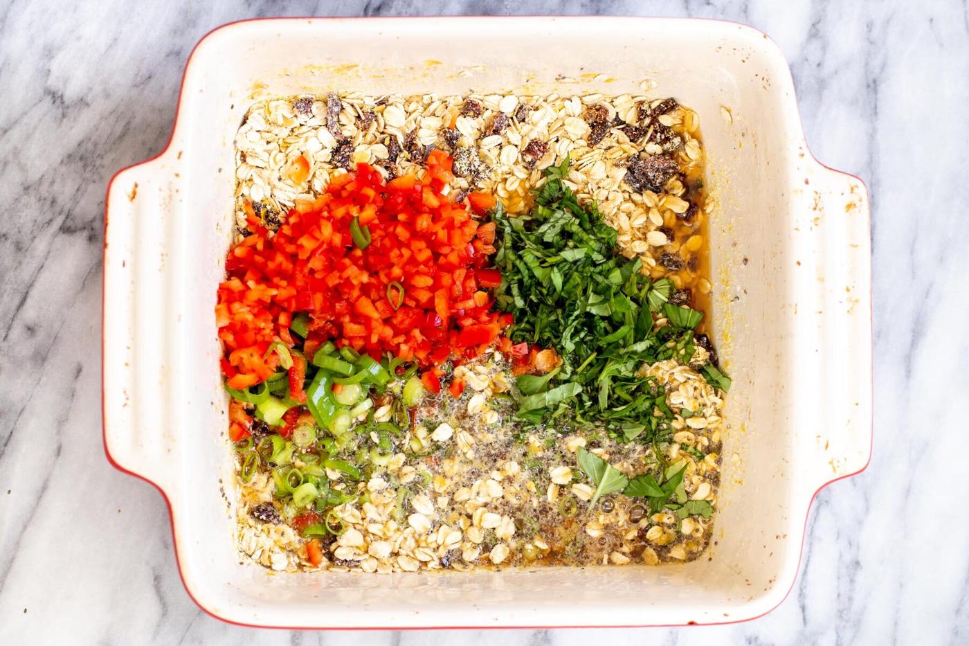 bell peppers and spring onions being added to dry ingredients in a casserole dish