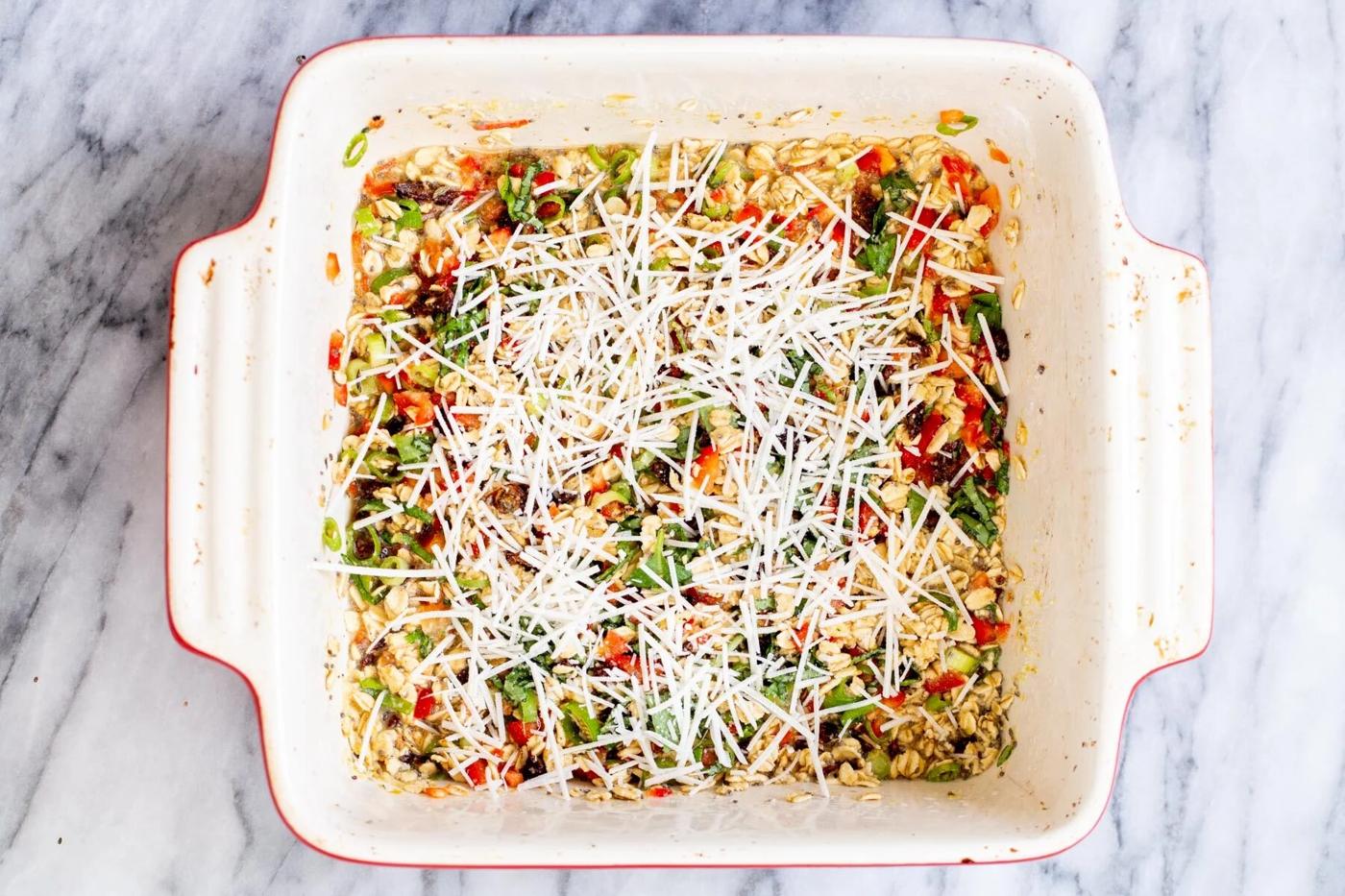 pizza baked oatmeal topped with shredded vegan mozarella