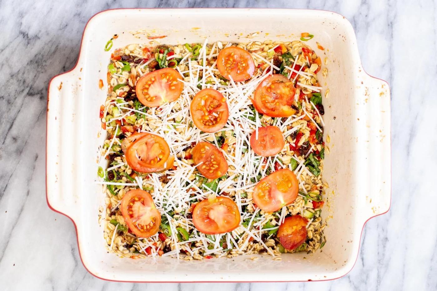 savory oatmeal bake topped with shredded mozarella and tomatoes