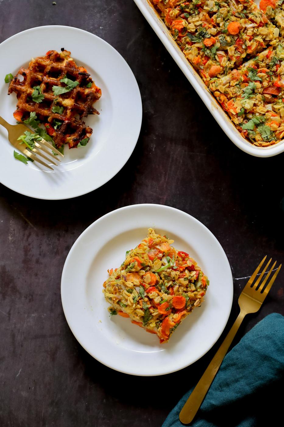 a piece of savory baked oats on a white plate next to the baking pan and a waffle