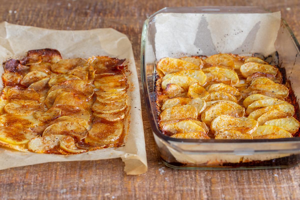 vegan scalloped potatoes in a casserole dish and on a sheet of baking paper
