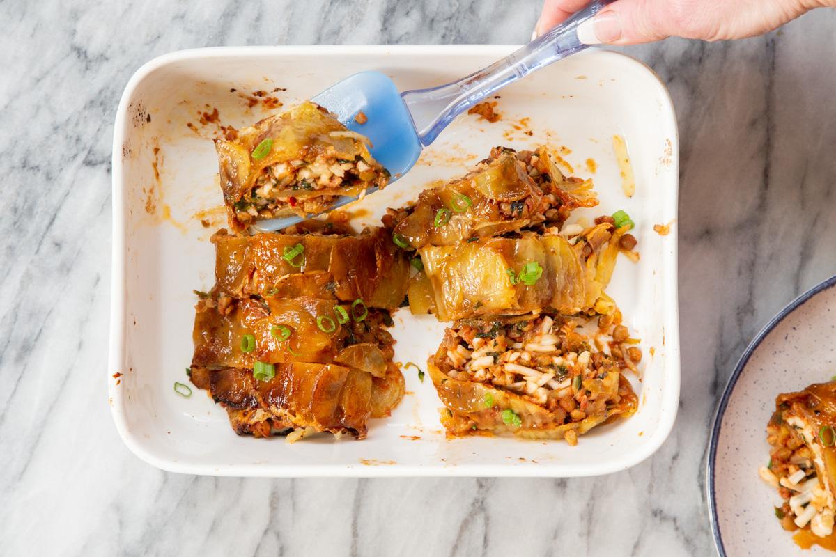 vegan scalloped potato rolls in a white casserole dish