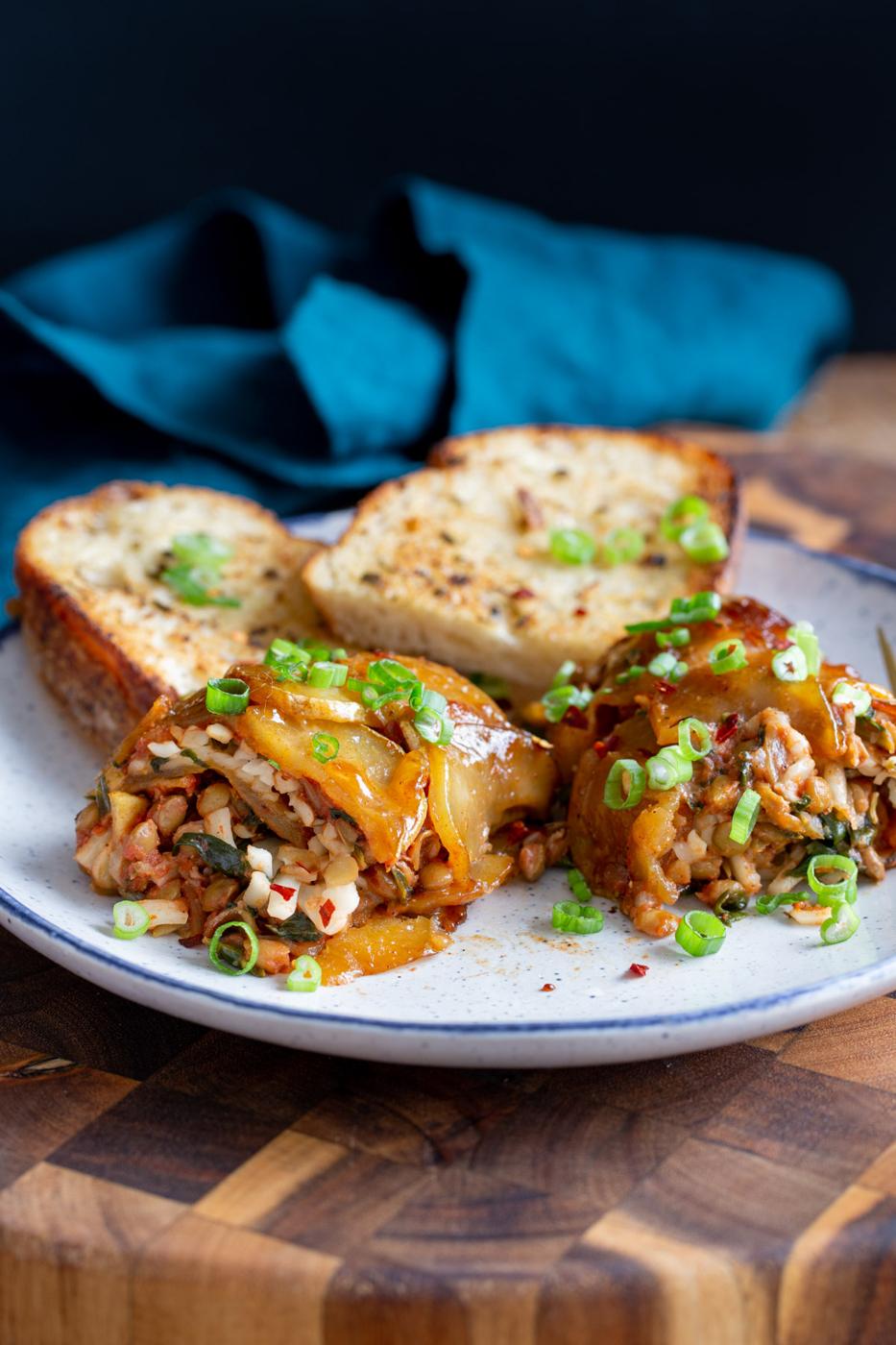 a serving of vegan scalloped potato rolls served with slices of bread