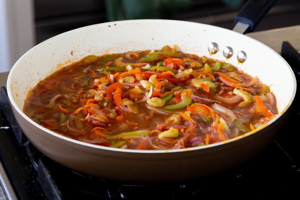 veggies mixed with the Szechuan sauce in the pan