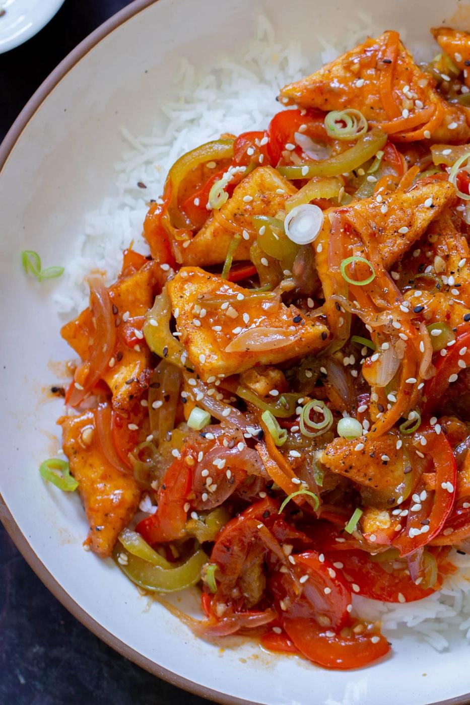 Szechuan tofu in a bowl with rice