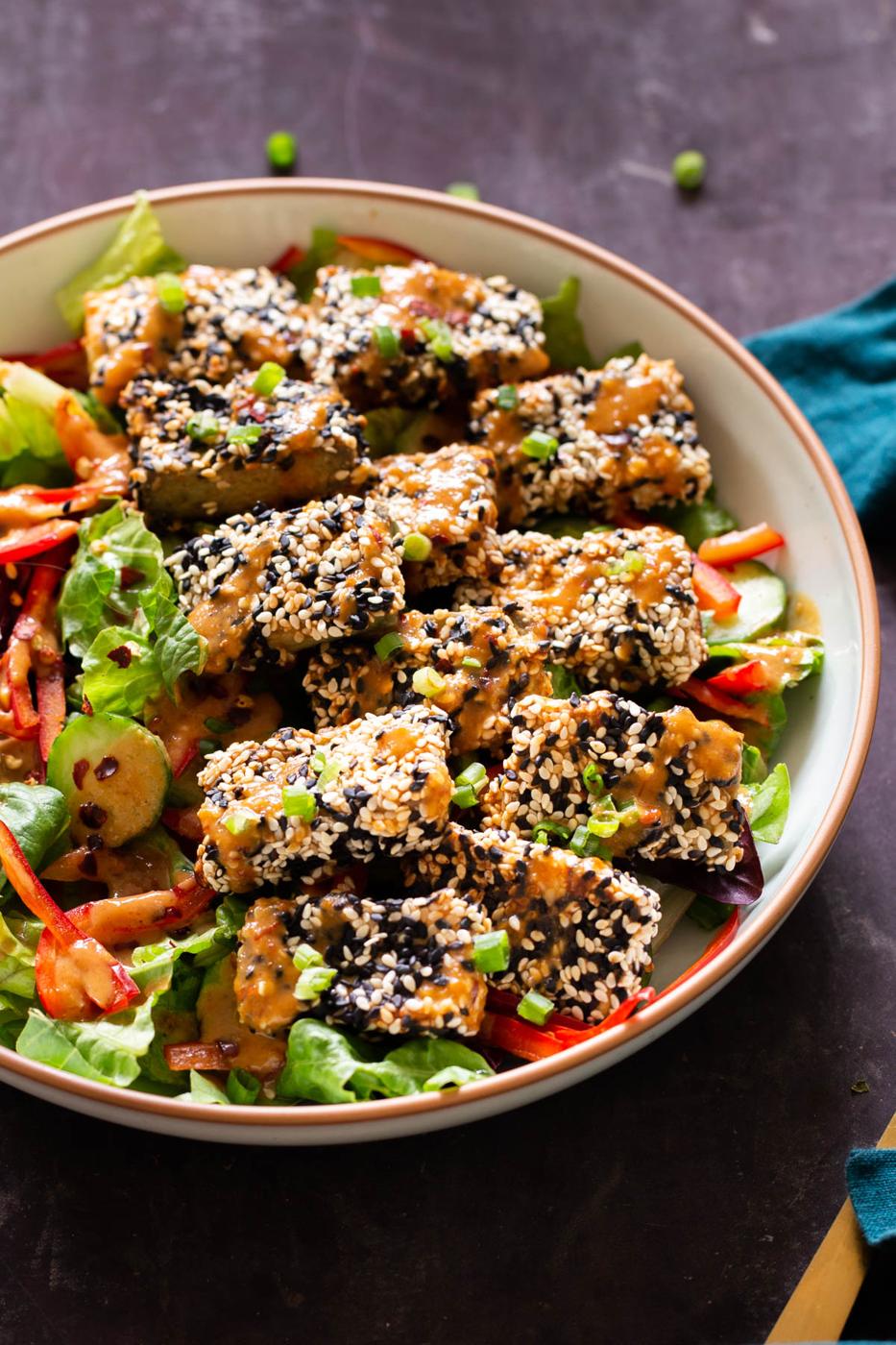 vegan sesame crusted baked tofu bowls drizzled with homemade peanut sauce