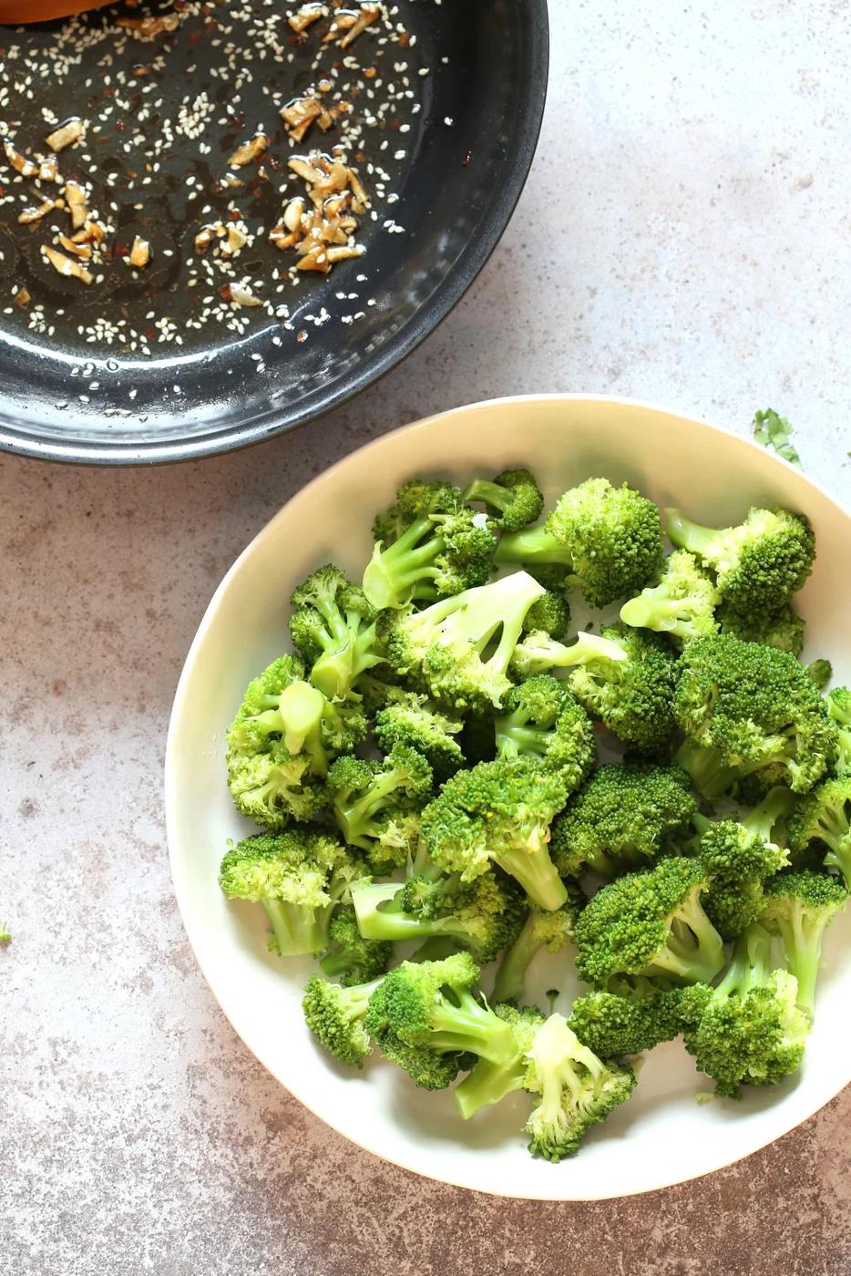 Sesame Garlic Broccoli needs just 6 ingredients. It is vibrant with blanched broccoli and delicious with a simple dressing of garlic roasted with sesame oil. A perfect side. #Vegan #glutenfree #soyfree #nutfree #veganricha #recipe