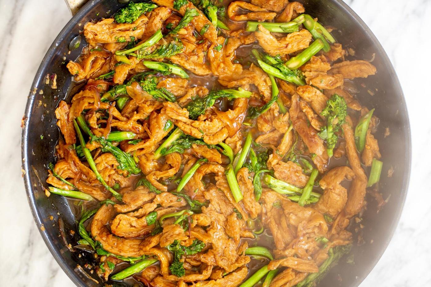 soy chunks with broccolini and Thai basil in a sauteeing pan