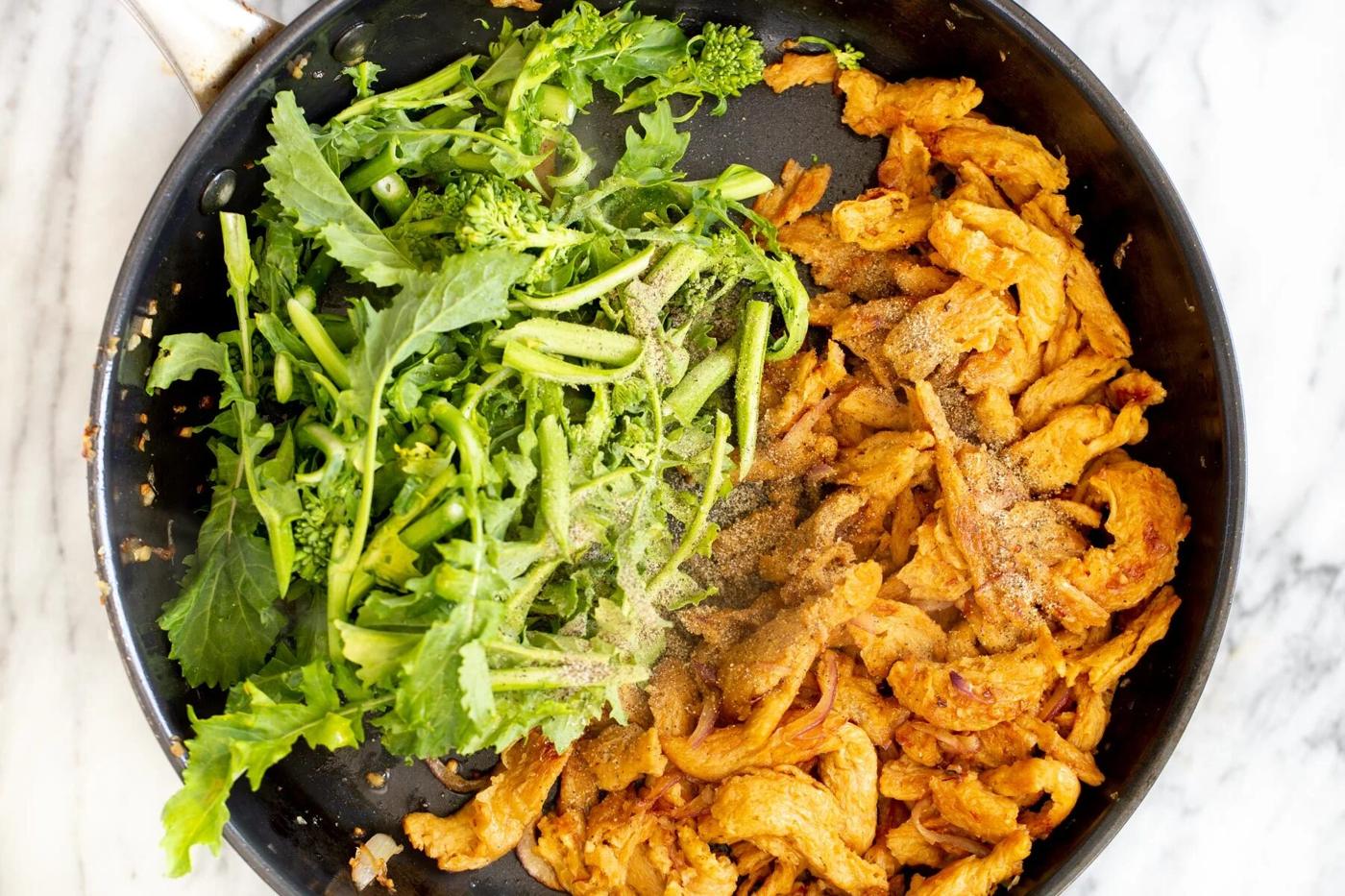 chinese broccoli and fried soy chunks in a sauteeing pan